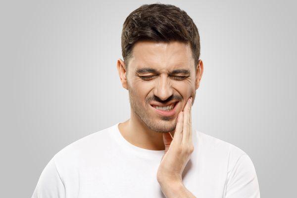 north york man holding jaw from tooth pain